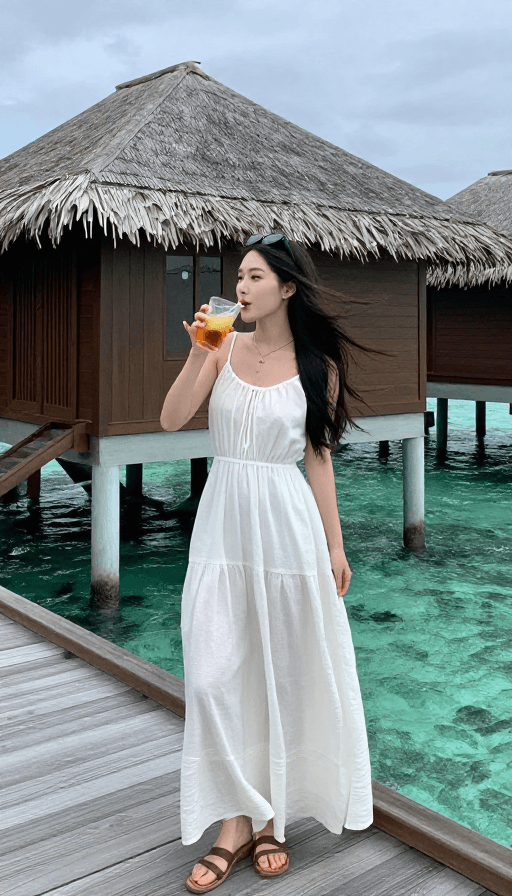 写实摄影素材：马尔代夫木屋前白衣女子的悠闲瞬间