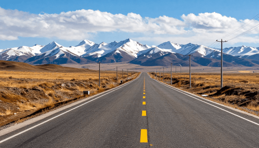 公路风景素材：雪山下的笔直公路：极致光影与旅途之美